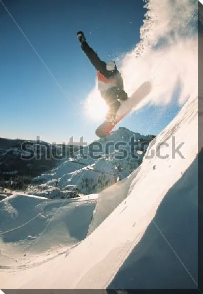 Постер Сноубордист парит в воздухе в момент эффектного прыжка с высокой горы на фоне прекрасного заснеженного пейзажа