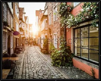 Картина Красивое закатное солнце на старинной улочке Шнорс кофейнями и магазинчиками в Бремене