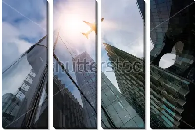 Модульная картина Самолёт над стеклянными небоскрёбами в лучах яркого солнца