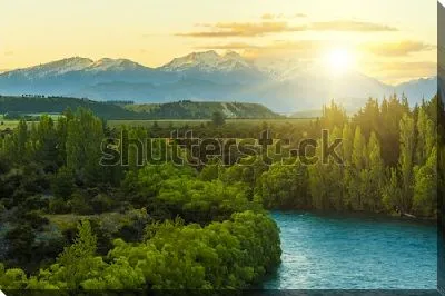 Фантастический пейзаж с восходом солнца над Южными Альпами и зелёными лесами в бассейне реки Клута (Новая Зеландия)