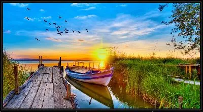 Картина Лодка у причала на фоне заката