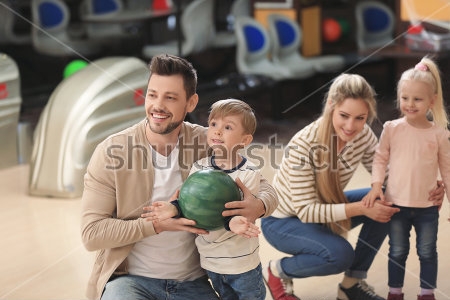 Картина Счастливая семья с детьми весело проводит время за игрой в боулинг 