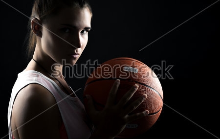 Постер Портрет красивой девушки с баскетбольным мячом на чёрном фоне  