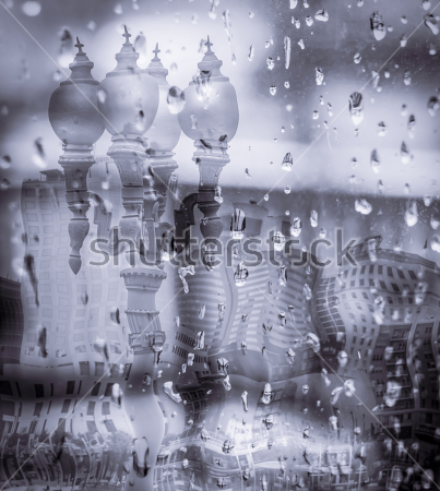 Картина Вид на город через окно в каплях дождя 
