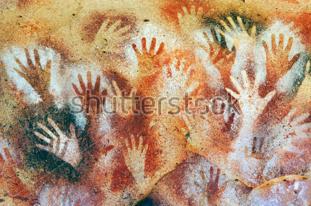 Постер Разноцветные силуэты рук на стене пещеры  