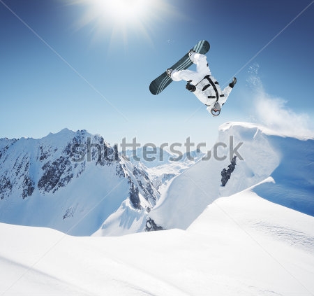 Картина Сноубордист в момент эффектного прыжка через голову в высоких снежных горах 
